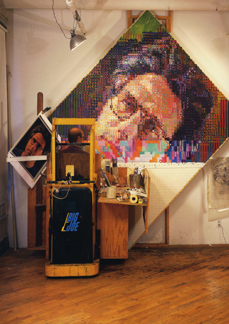 photo of Chuck Close working on his painted portrait of Eric, 1990
