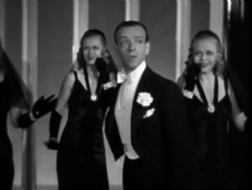 Fred Astaire dances with girls in Ginger Rogers masks.